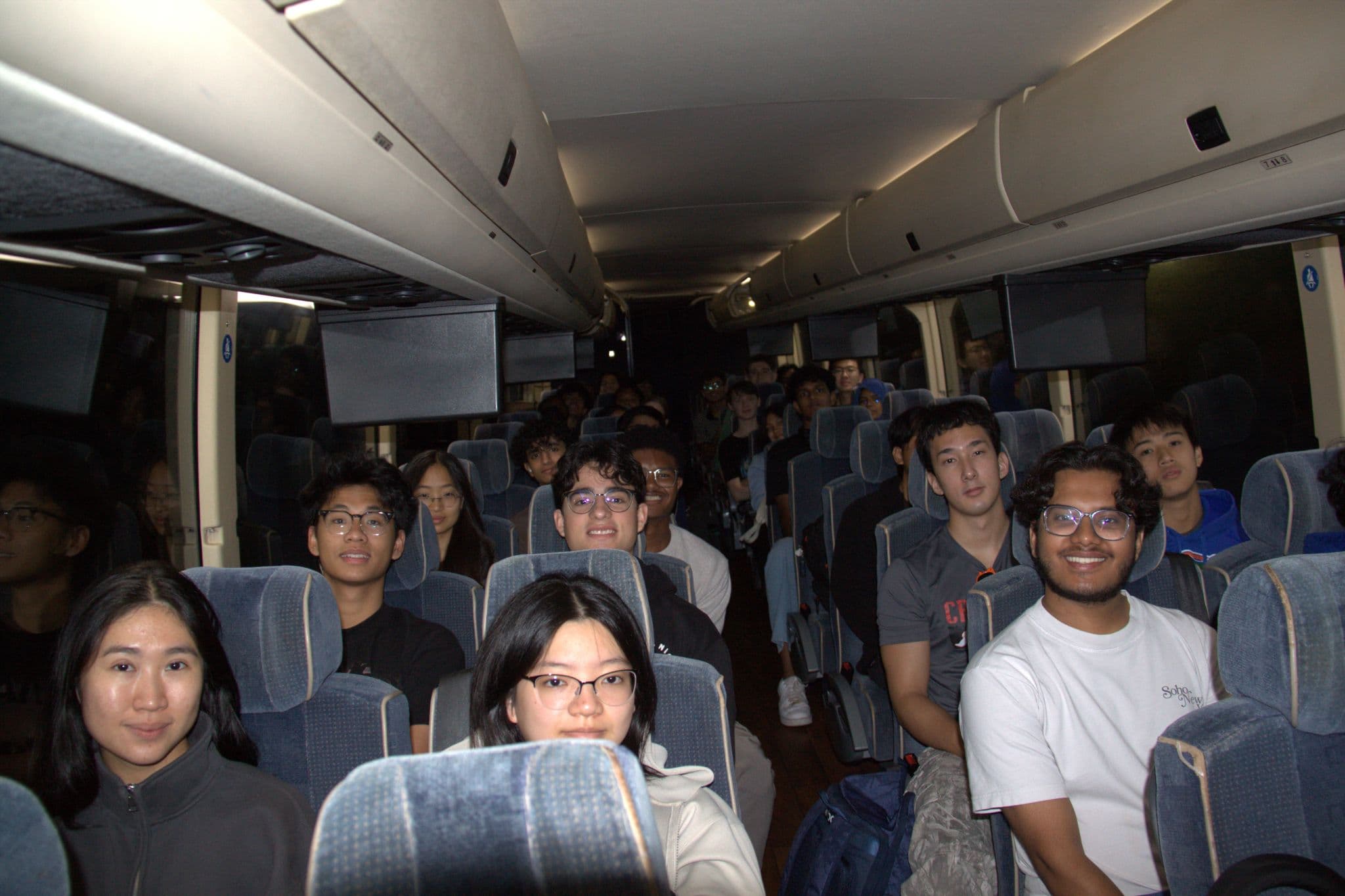 DSI members smiling from their seats on a charter bus