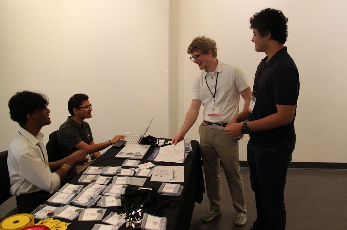 Volunteers checking in attendees at a table of name badges